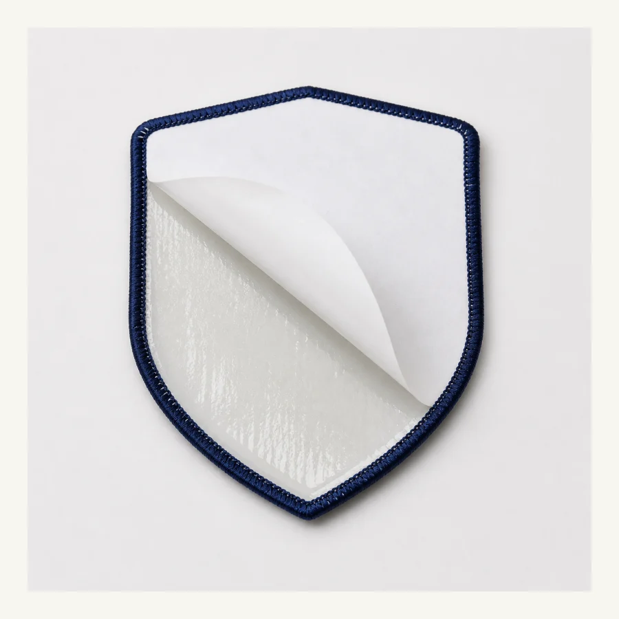 Self-adhesive backing peel layer on custom patch